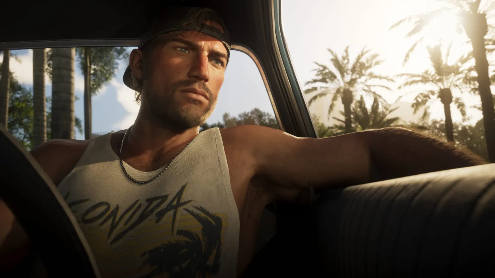 Jason, a GTA 6 protagonist, driving a convertible down a palm-lined Vice City road in daylight