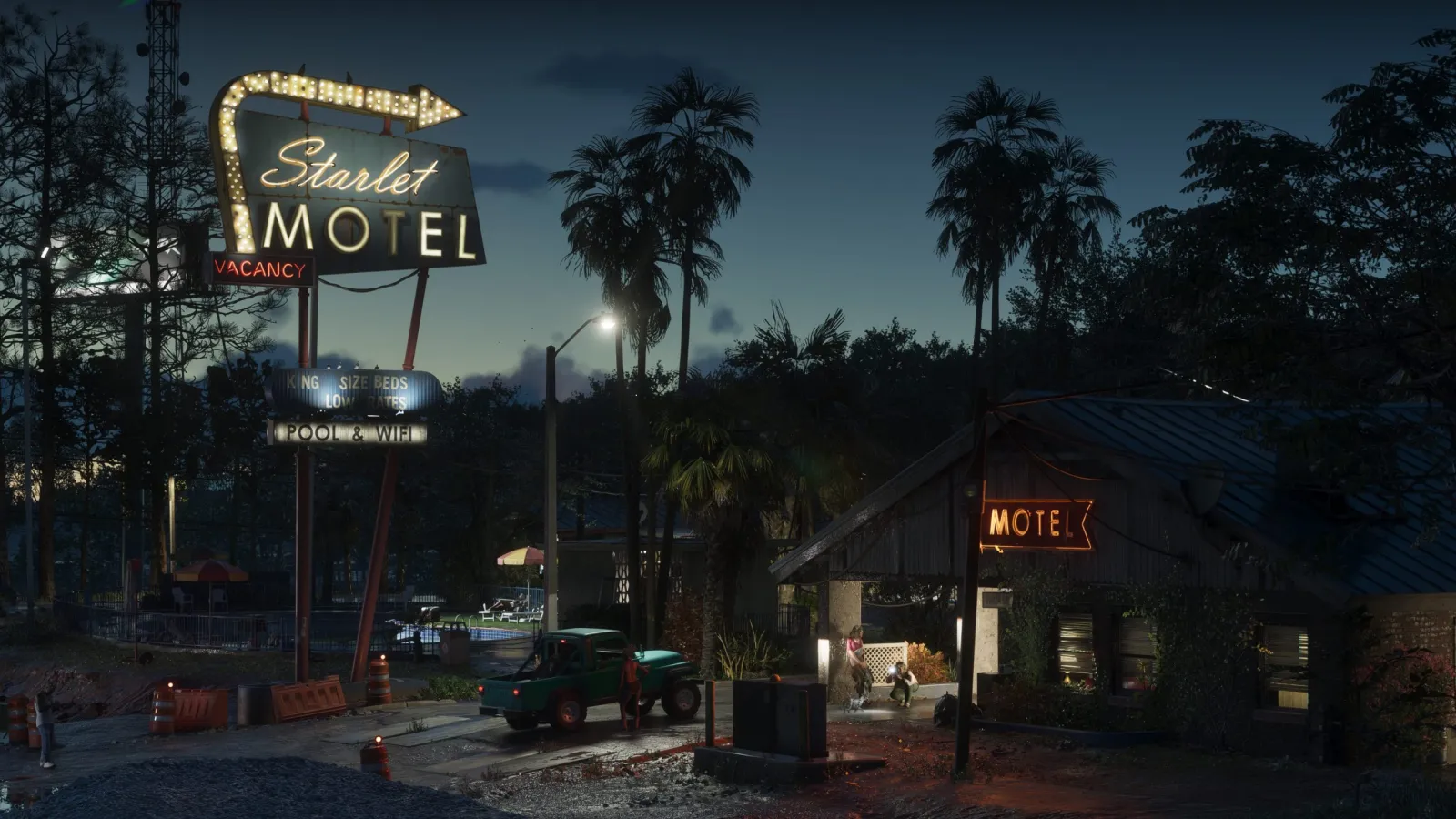 The retro neon sign of a motel glowing at dusk in GTA 6's Port Gellhorn, with palms and a pickup truck